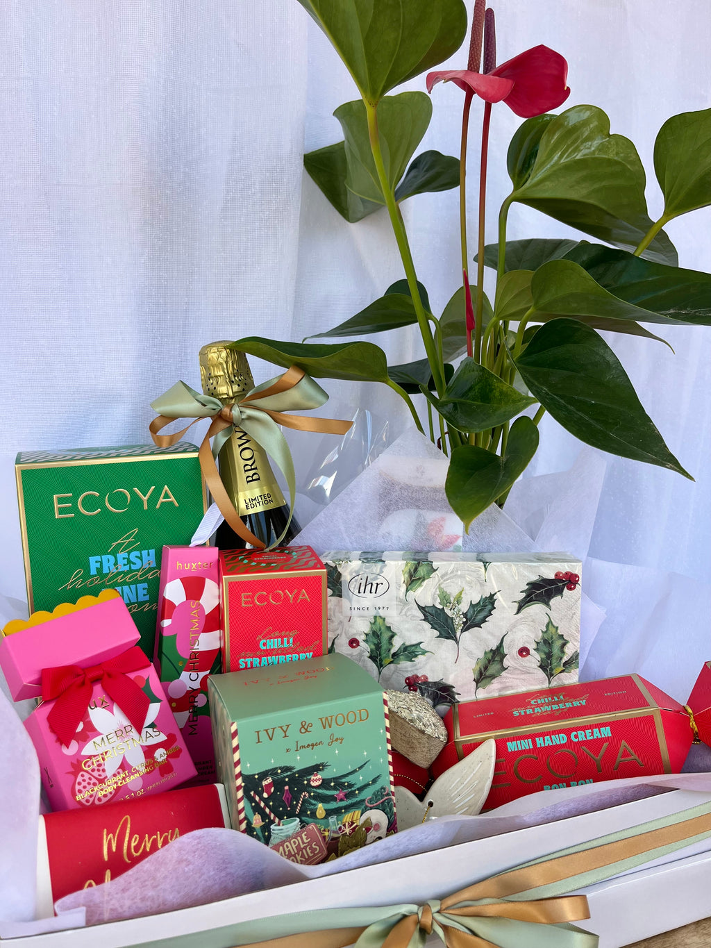 Assorted gift boxed hampers  with decorative ribbons with a potted plant and luxury gifts. Hamper delivery Brisbane. 