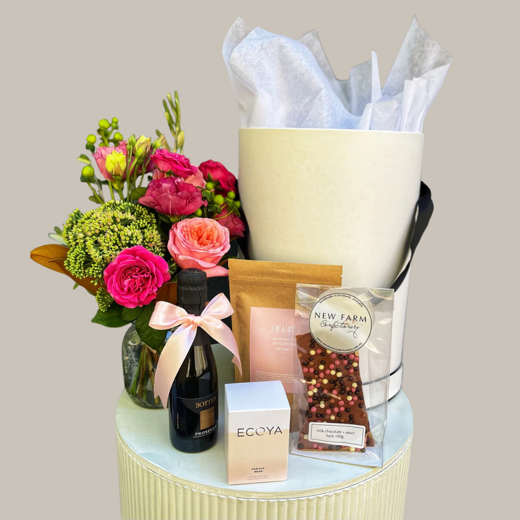 Gift set with flowers, champagne, chocolate, bath salts and a candle. Kenmore Village Florist. Brisbane Flower Delivery.