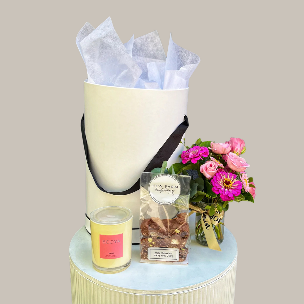 Gift hamper with flowers, candle, and chocolate. Kenmore Village Florist. Brisbane hamper delivery.