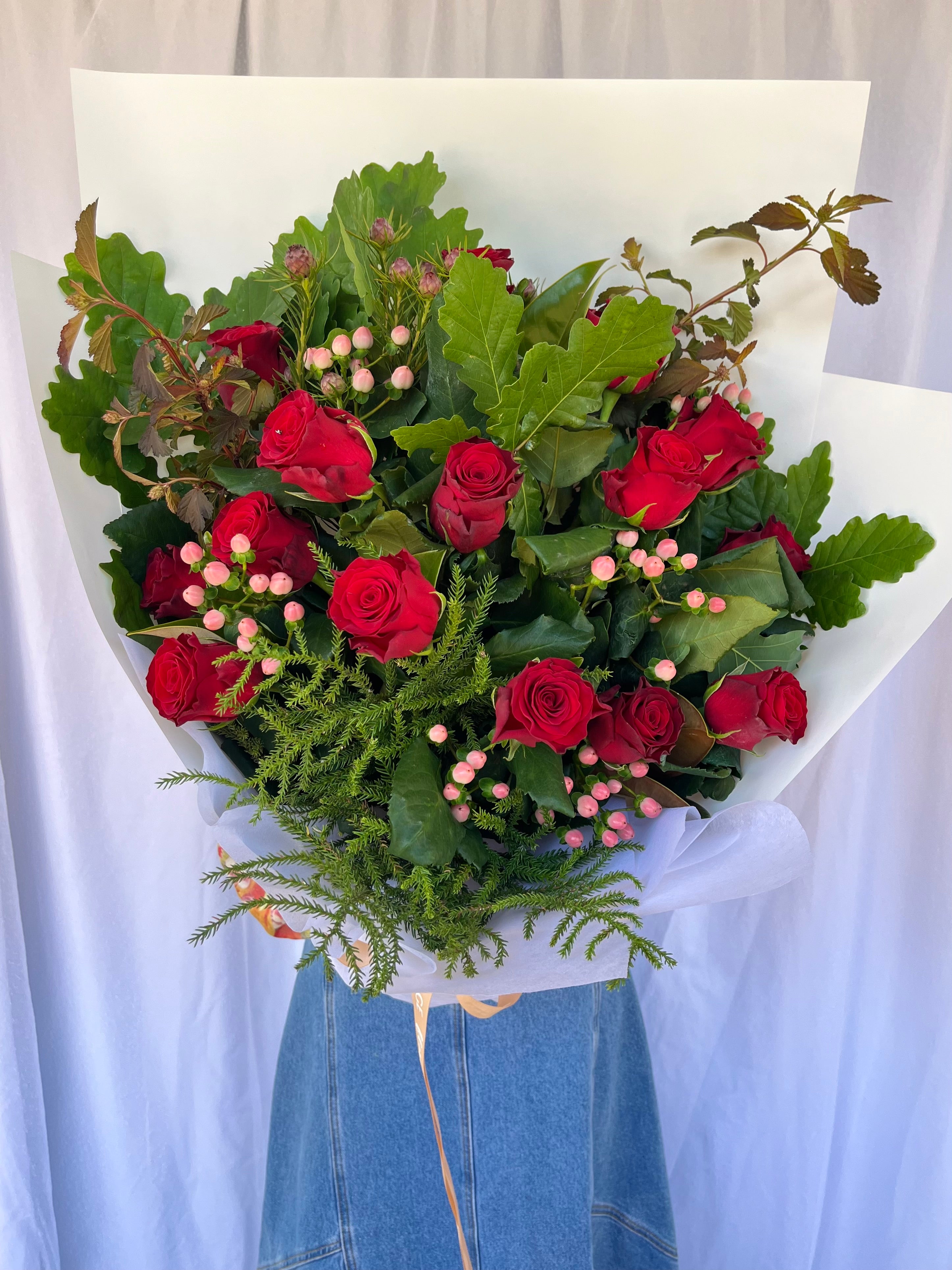 Bouquet of red roses and greenery for Christmas gifting. Kenmore Village Florist. Brisbane flower delivery.