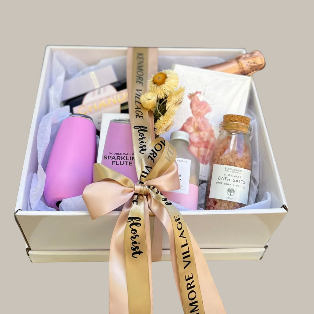 Gift box with spa items including bottles, a bottle of champagne, and bath salts. Will you be my bridesmaid? Brisbane Hamper delivery. Same day delivery available. Kenmore Village Florist.