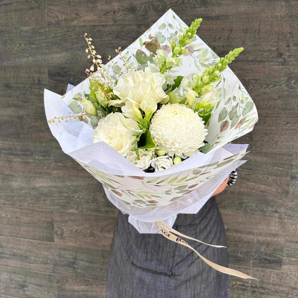 A Petite Sympathy Bouquet featuring a mix of white and green flowers. Sympathy Flowers. Kenmore Village Florist, Brisbane Flower Delivery.